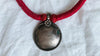 Antique Indian Silver Pendant on a Wrapped Red Cord.
